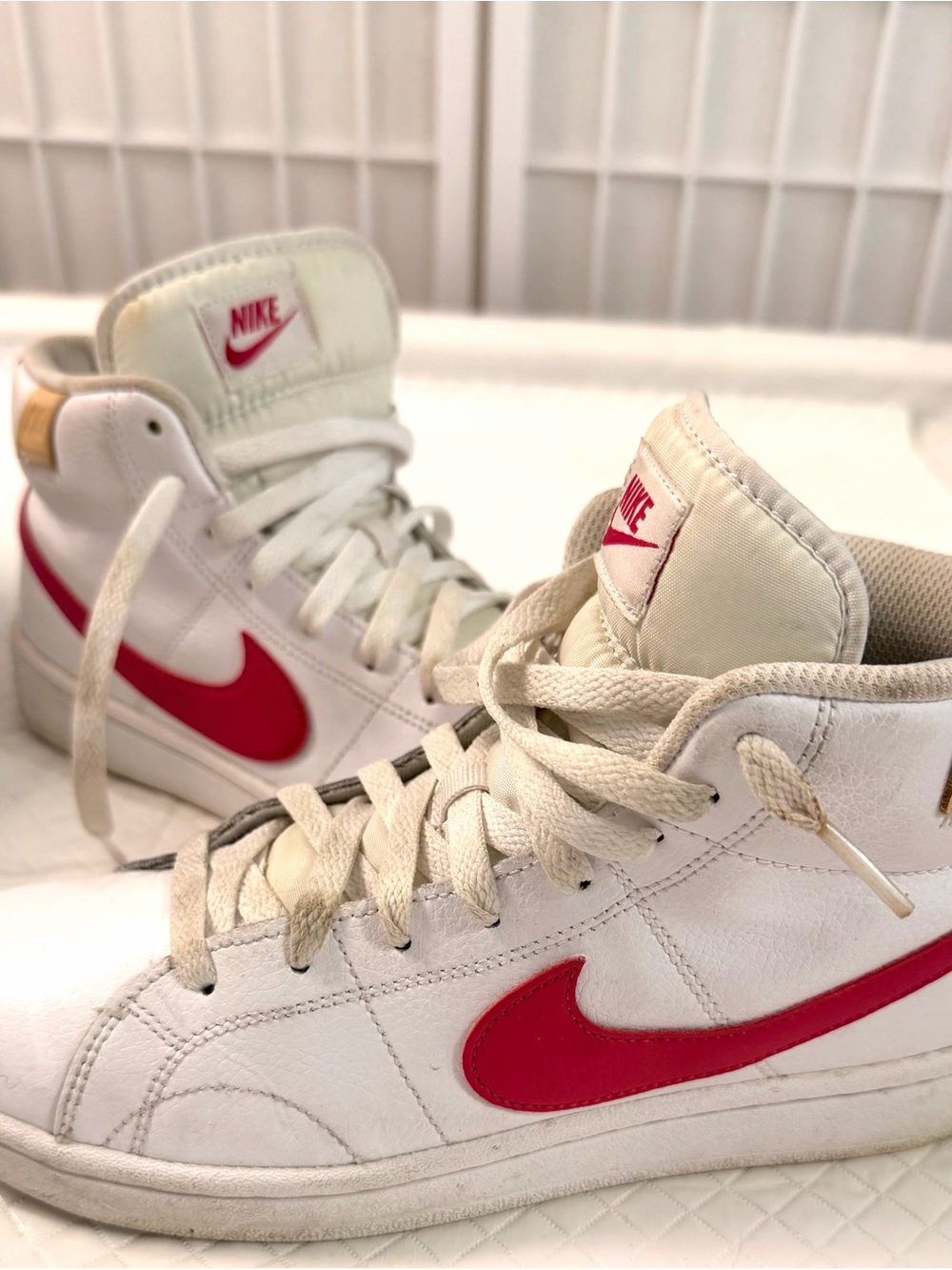 Nike women’s size 8.5. White High-Top Nike Sneakers with Red Swoosh